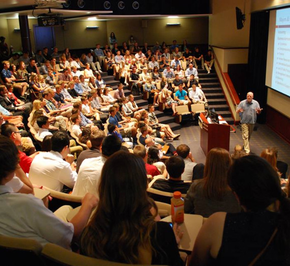 Woman in a t-shirt with a star on it leans against a railing
